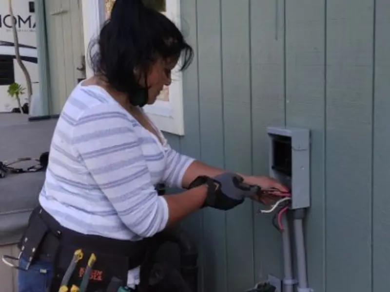 Licensed electrician wiring an exterior subpanel in Waverly